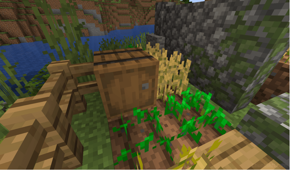 A barrel sits surrounded by growing crops and a cobble stone wall with moss growing on it.