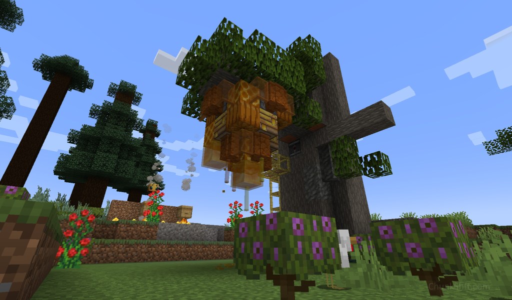 A large bee nest made of bee hives, pumpkins honeycomb, red sandstone walls and yellow glass hangs from a partially built custom tree.