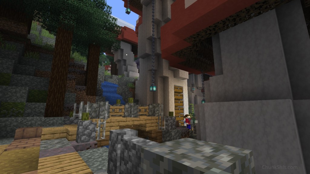 Custom mushrooms line the right hand side of the image and spruce trees the right. A path leaves the viewer and crosses a bridge. The payer is seen here interacting with a stack of chests built into one of the custom mushrooms. 