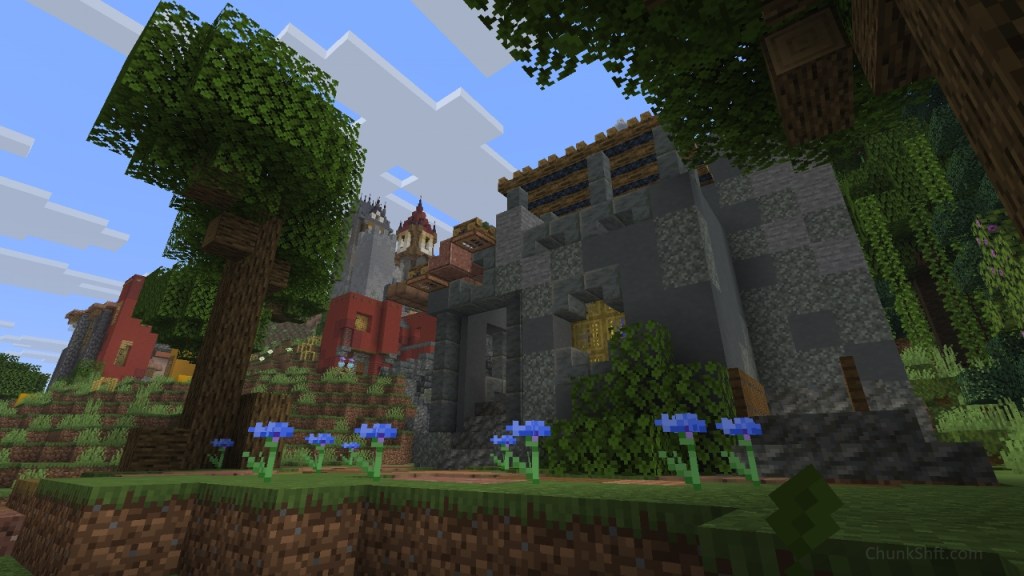 A building of cyan terracotta, pale moss and stone dominates the image. Flanked by tall oaks and corn flowers in the foreground. A small covered walkway is on the left of the building, a small window centre with bamboo trap doors in place of glass and a balcony atop with campfires as an awning. 