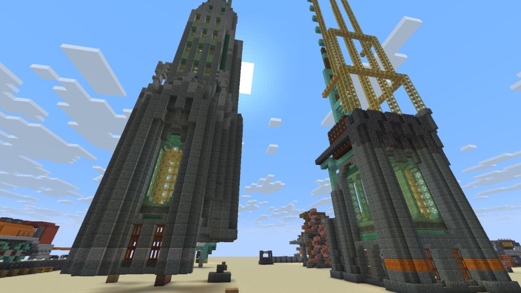 Two art-deco towers rise towards the sky. One more complete the other with scaffolding framing its upper shapes. Largely built of tuff with copper framing bamboo windows.