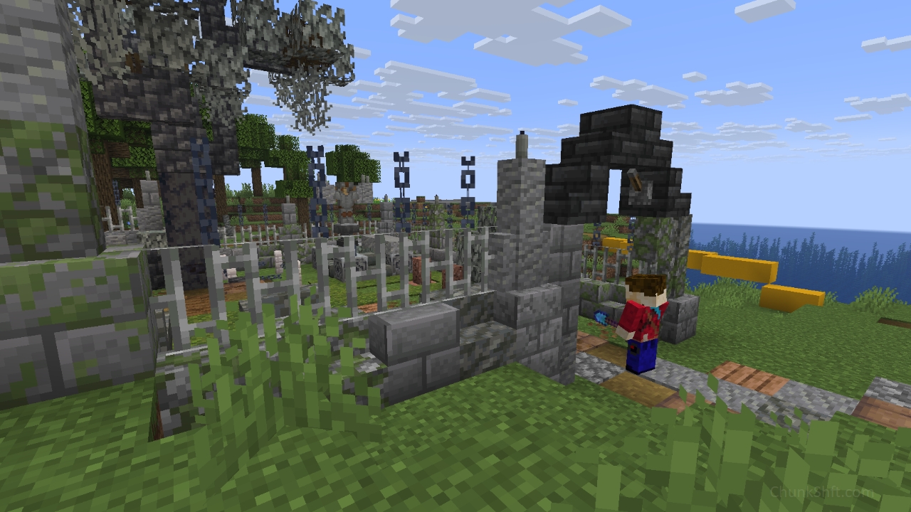 The player stands in the arched entrance of a graveyard. A stone and iron fence surrounds the graveyard, The stone base and partitions have been weathered with moss growing on some.