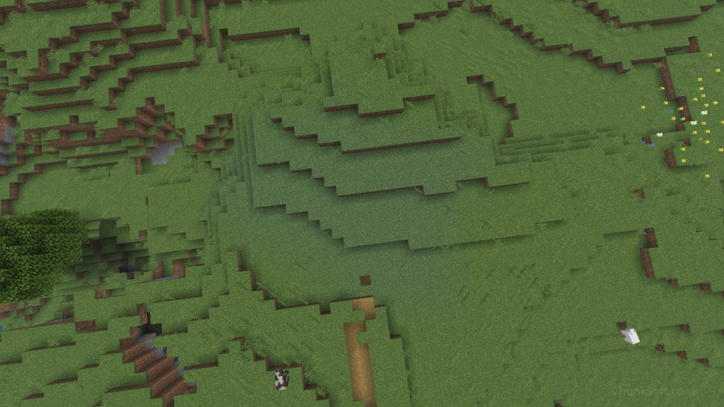 A aerial view of a plains biome. A path enters the bottom of the image and ends at a patch of blueish grass centred in the image.