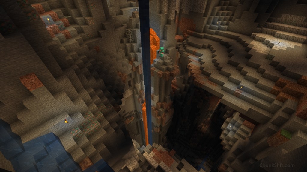 The player, barely visible stands atop a stone pillar. Water and lava descend into the deepslate below. Dripstone blocks dot the cavern with much already stripped out by the player.