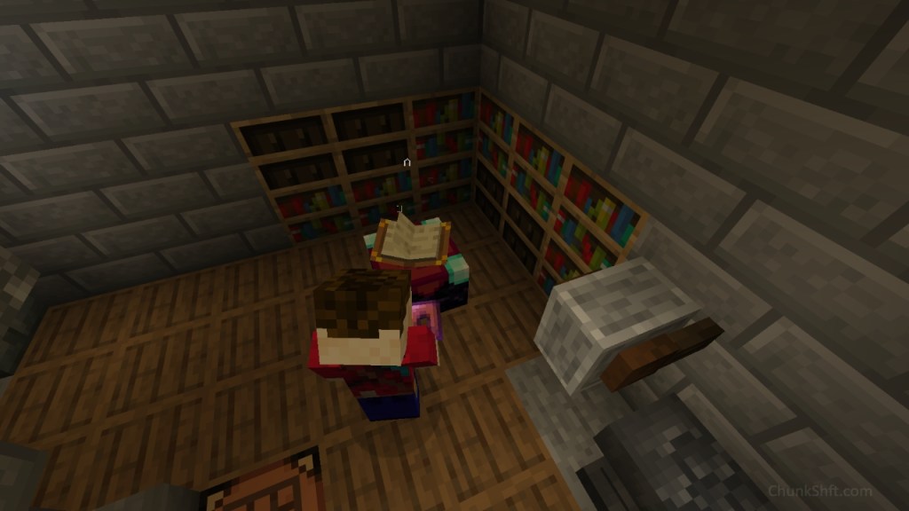 A enchanting table sits in the corner of a dark stone wall room. Chiseled book shelves and 8 bookshelves are in the corner. The floor is upside down barrels and grind stone and cracked anvil are in the corner. The play stands at the enchanting table with copper leggings.